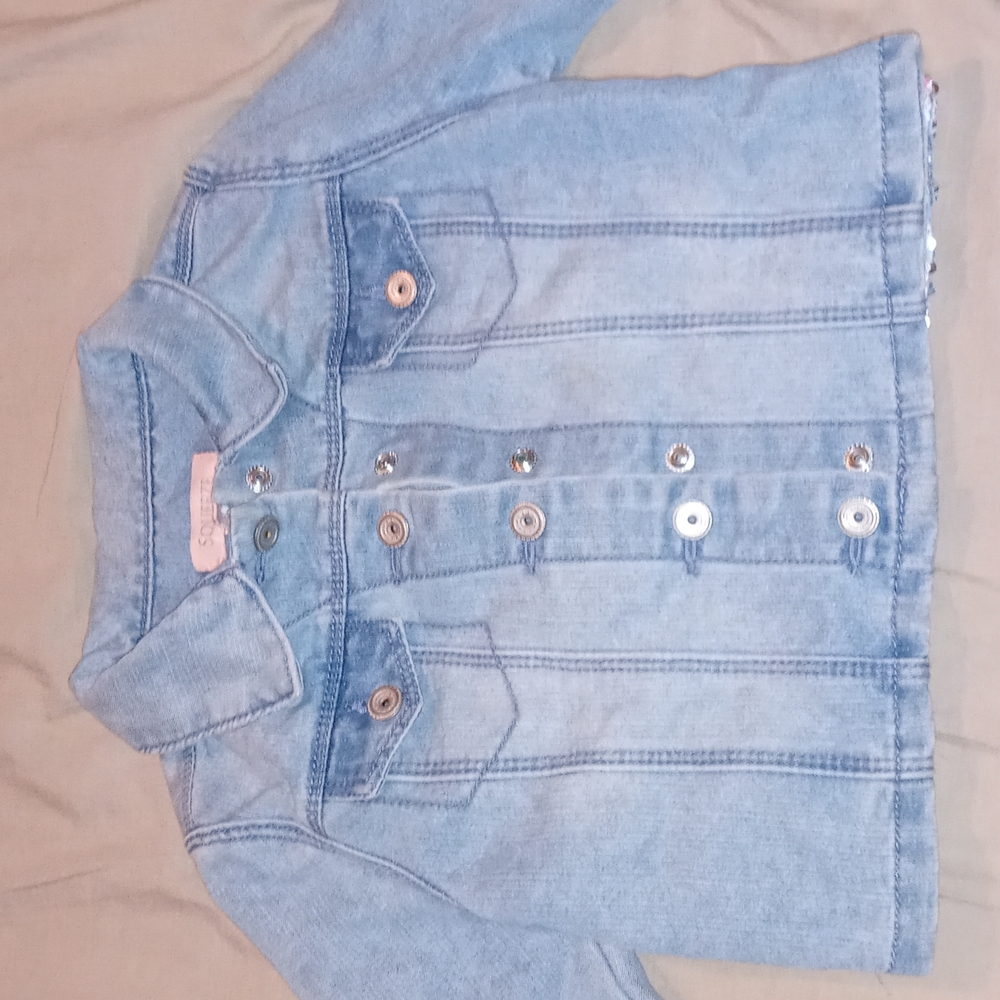 Squeeze jean jacket multi-color sequence on back.